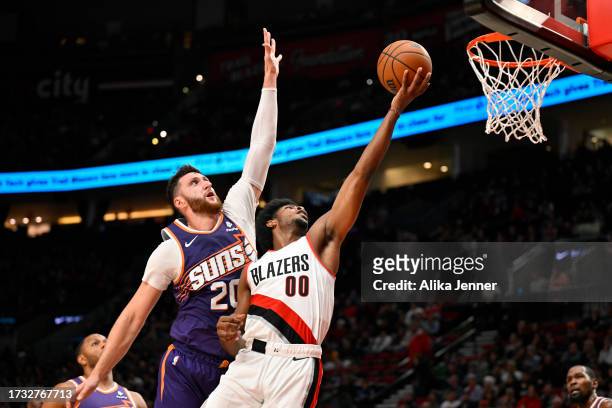Scoot Henderson of the Portland Trail Blazers shoots against Jusuf Nurkic of the Phoenix Suns during the second quarter of the preseason game at Moda...