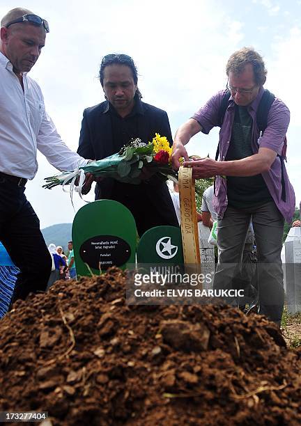 Dutch soldiers, ex-members of the UN mission to the "Safe enclave of Srebrenica", Adje Anakotta , Dion Vandenberg and Dave Maat , lay flowers on the...