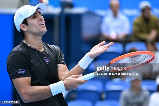 Chile's Christian Garin reacts during the men's singles match against Australia's Alexei Popyrin on day four of the ATP Japan Open tennis tournament...