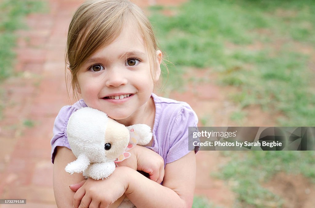 Young girl hugging a toy