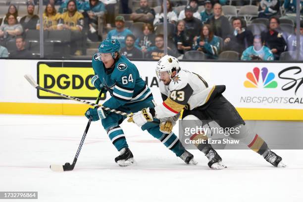 Mitchell Russell of the San Jose Sharks controls the puck in front of Paul Cotter of the Vegas Golden Knights in the third period at SAP Center on...