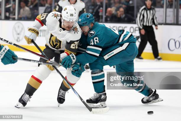 Chandler Stephenson of the Vegas Golden Knights and Tomas Hertl of the San Jose Sharks go for the puck in the third period at SAP Center on October...