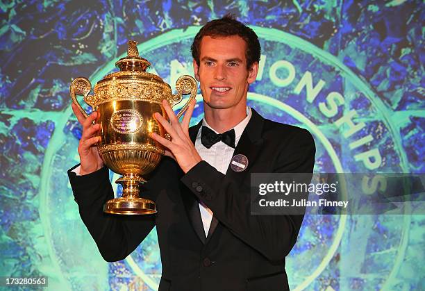 Andy Murray of Great Britain poses with the Gentlemen's Singles Trophy during the Wimbledon Championships 2013 Winners Ball at InterContinental Park...