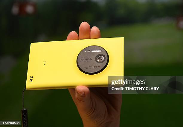 Employee demonstrates the photo capabilities of the Nokia Lumia 1020, a Windows Phone with a 41-megapixel camera after its unveiling in New York City...