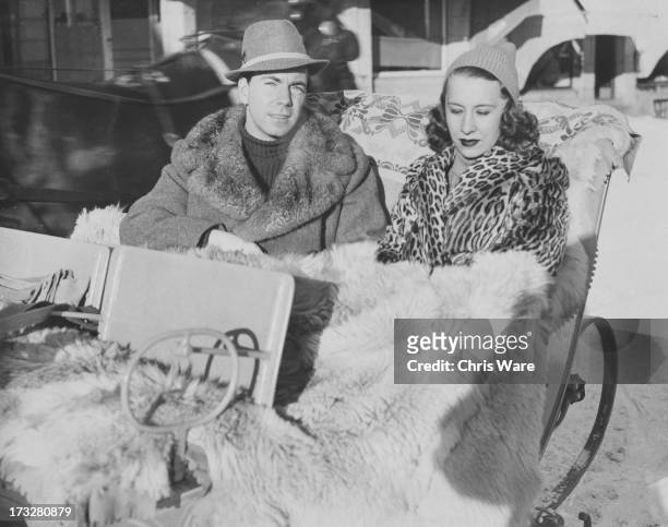 Count Sigvard Bernadotte of Wisborg and his wife Erica Maria Patzek take a sleigh ride on their arrival in St. Moritz, Switzerland, 4th January 1938.