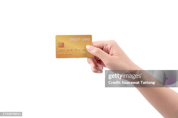 female hand hold a gold plastic bank card on a white background - specimen holder stockfoto's en -beelden