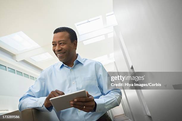 office worker using digital tablet - african at the bank stock pictures, royalty-free photos & images