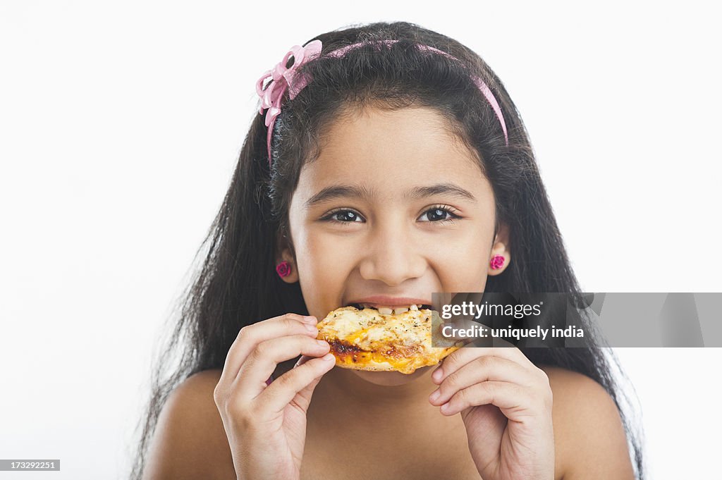 Girl eating pizza