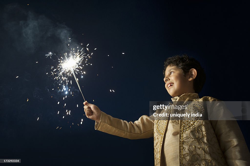 Boy burning fire crackers on Diwali