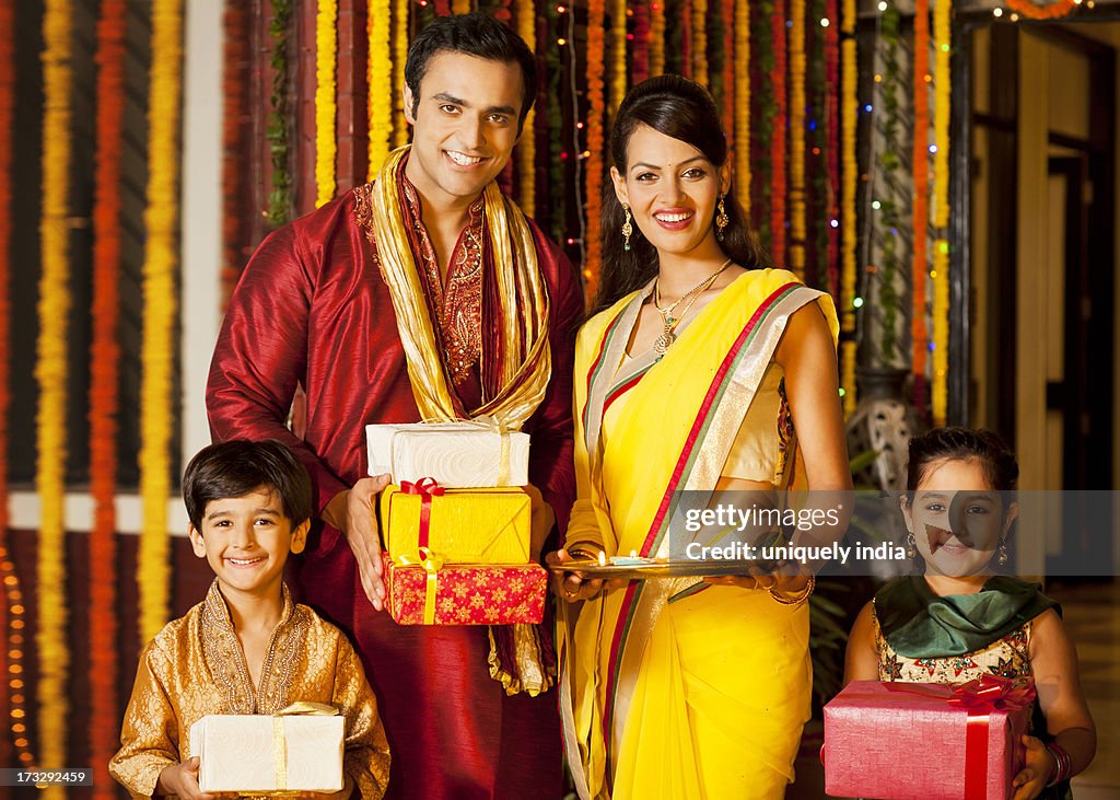 Family holding gifts on Diwali