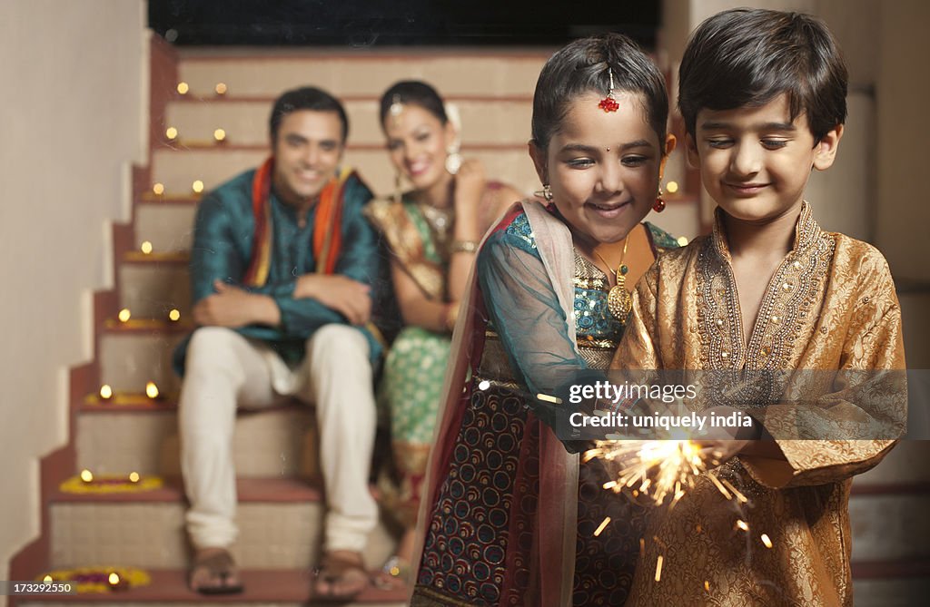 Family burning fire crackers on Diwali