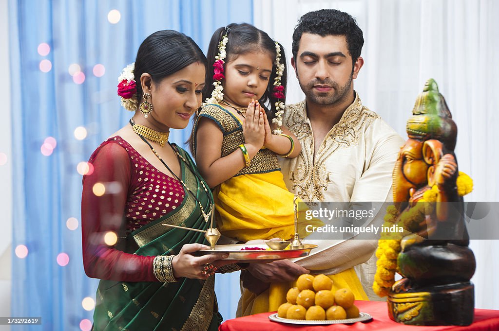 Maharashtrian family praying Lord Ganesha at Ganesh Chaturthi