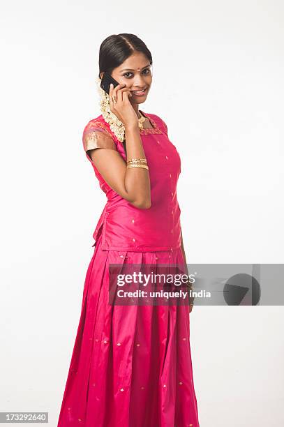 south indian woman talking on a mobile phone - south asian females on phone isolated stock-fotos und bilder