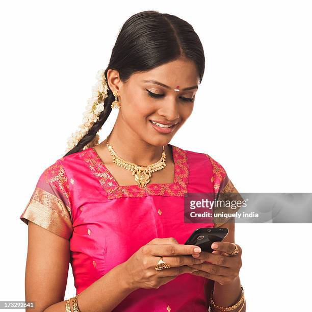 south indian woman text messaging on a mobile phone - south asian females on phone isolated stock-fotos und bilder