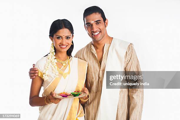 south indian couple smiling at onam - onam foto e immagini stock
