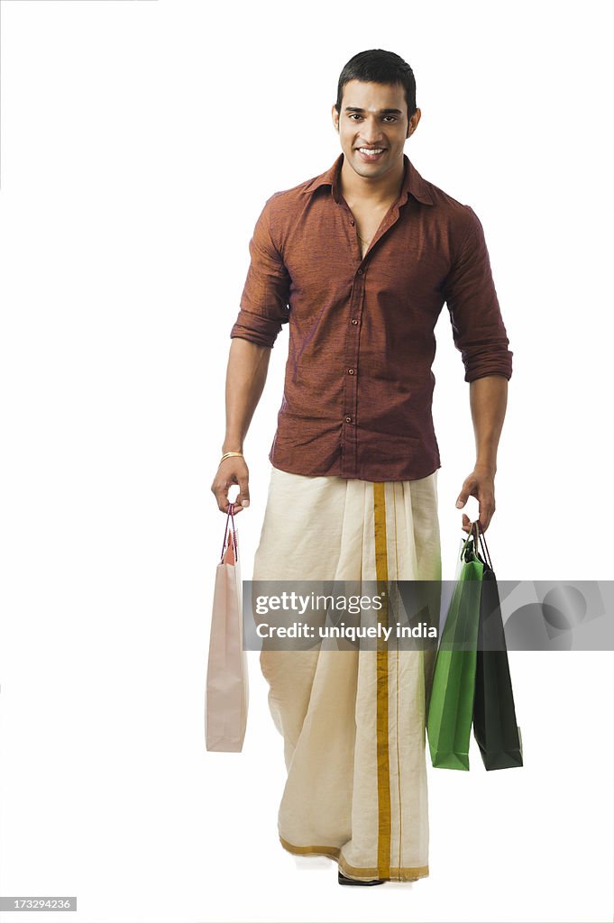 South Indian man carrying shopping bags