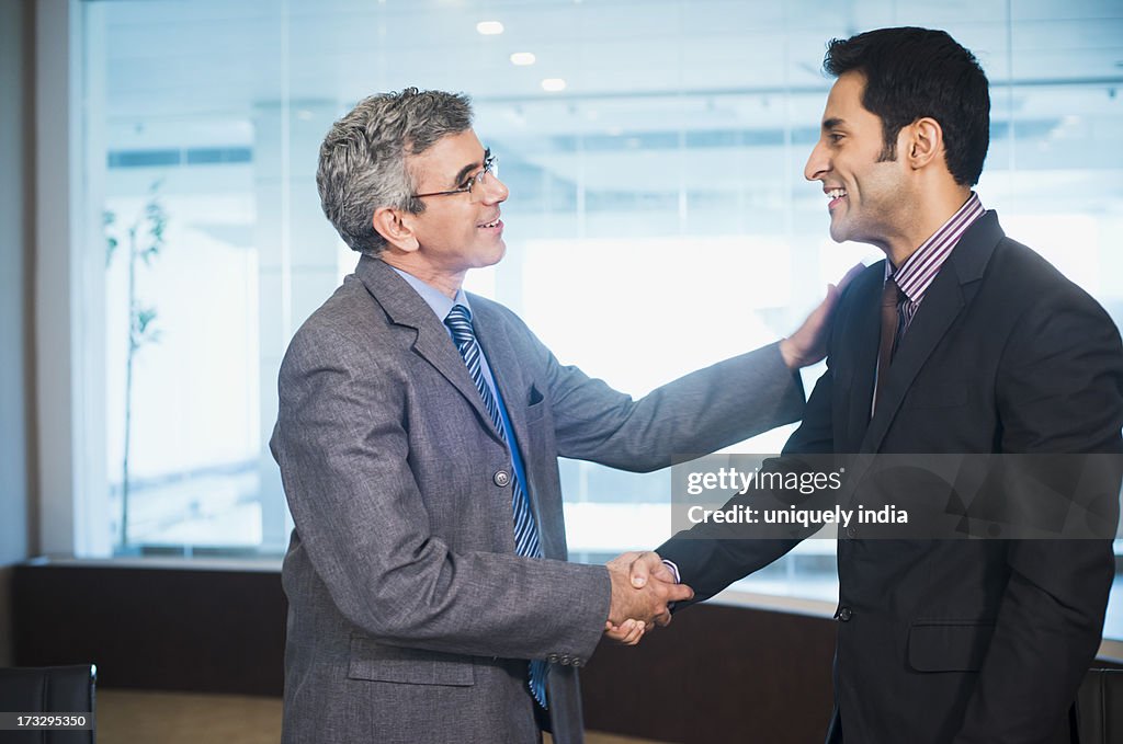Businessman shaking hands with another businessman