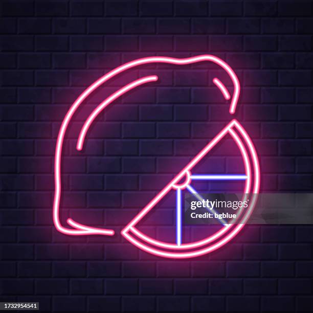 lemon and slice. glowing neon icon on brick wall background - lime slice stock illustrations