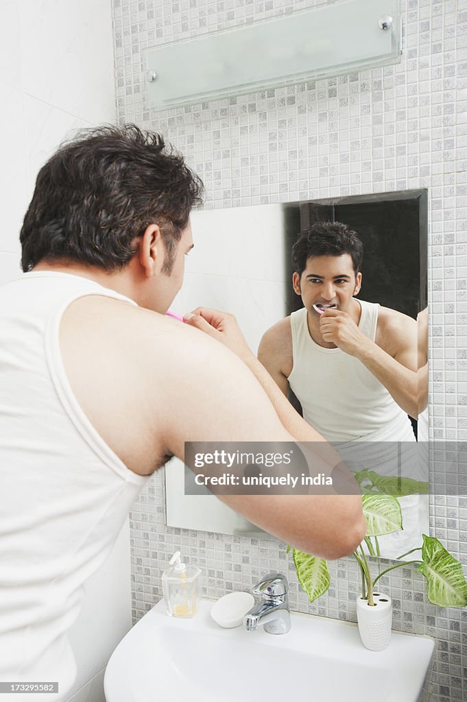 Man brushing his teeth in the bathroom