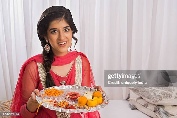 teenage girl holding a puja thali at raksha bandhan - raksha bandhan stock-fotos und bilder