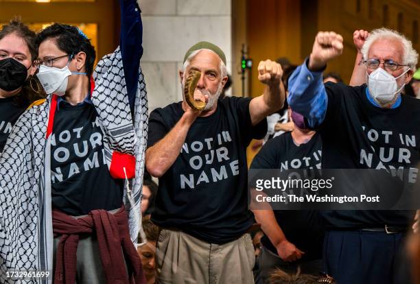 Protestors chant and blow the Shofa in the rotunda of the Cannon House Office Building to stage a sit down strike as Jewish Voice for Peace holds a...