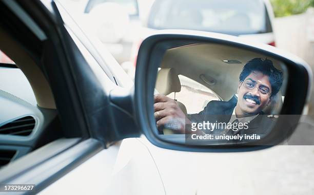 reflection of a south indian businessman in the side view mirror of a car - side view mirror stock pictures, royalty-free photos & images