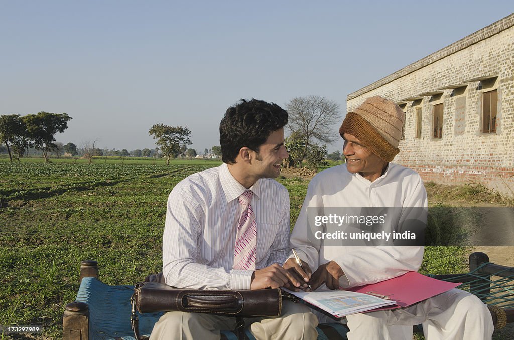 Farmer signing on the agreement of agriculture loan, Sonipat, Haryana, India