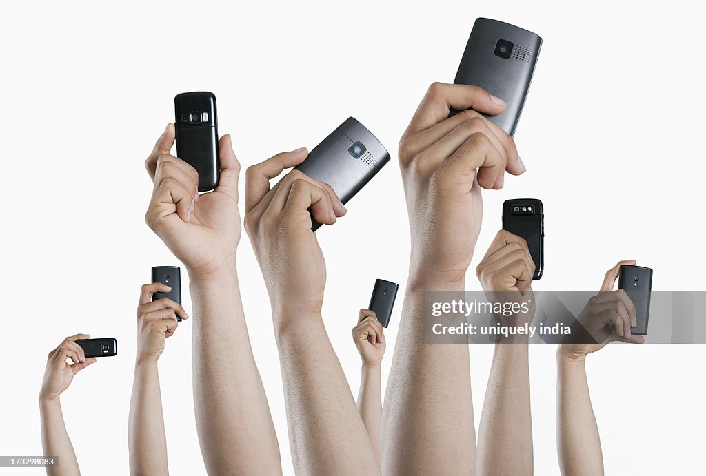 People's hands holding mobile phones