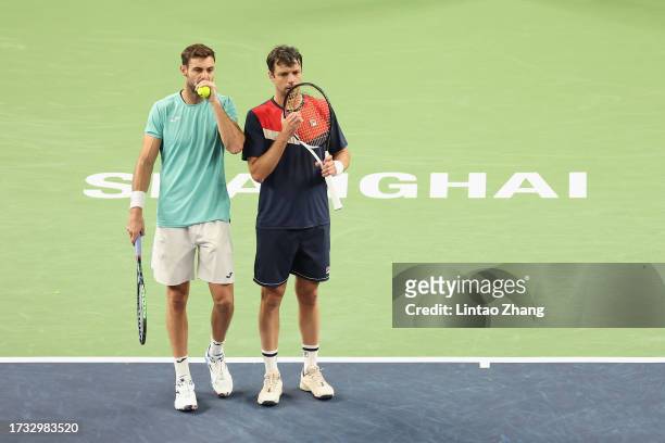 Marcel Granollers of Spain and Horacio Zeballos of Argentina talk during the match against Stefanos Tsitsipas of Greece and Robin Haase of...