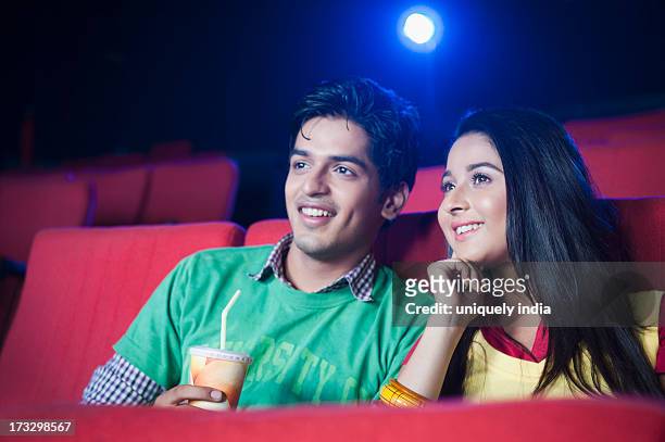 couple watching movie in a cinema hall - indian couple in theaters - fotografias e filmes do acervo