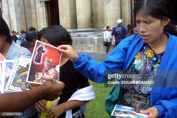 Mayan woman hands out photos o Pope John Paul II and Pedro de San Jose Betancourt,a Spanish monk 28 July 2002 in Guatemala City. Pope John Paull II ,...