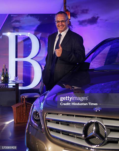 Mercedes-Benz India MD & CEO Eberhard Kerm posing with the newly launched Mercedes-Benz New B-Class 180 CDI luxury Tourer on July 11, 2013 in Mumbai,...