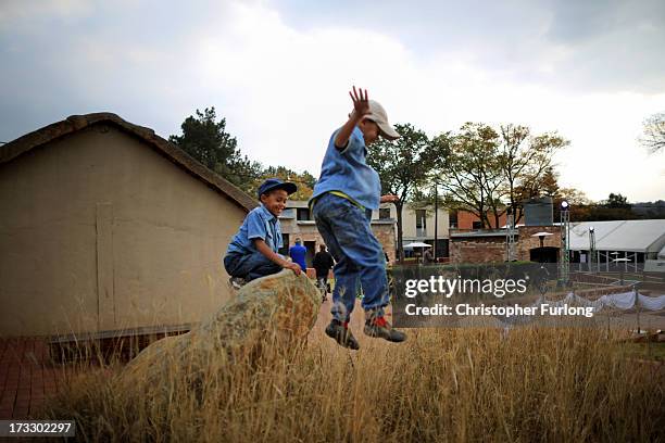 Young children play during anniversary celebrations at Liliesleaf Farm; the apartheid-era hideout for Nelson Mandela and freedom fighters in...