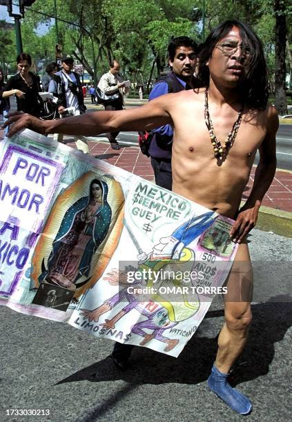 Jose Luis Chavez, known as "the Naked Poet", walks without clothes the streets in Mexico City, Mexico, 12 October 2000 carrying an image of the...