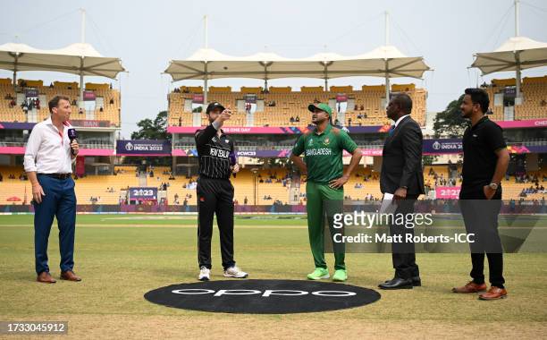 Kane Williamson of New Zealand flips the coin as Shakib Al Hasan of Bangladesh looks on ahead of the ICC Men's Cricket World Cup India 2023 between...