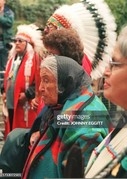 Year old Jessie, grandaughter of Long Wolf, stands 25 September with other members of her Oglala tribe family as the casket containing the remains of...