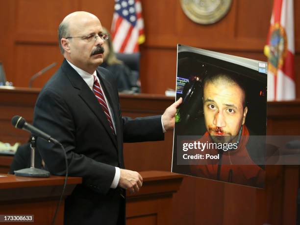 Assistant state attorney Bernie de la Rionda shows a picture of George Zimmerman to the jury while presenting the state's closing arguments against...