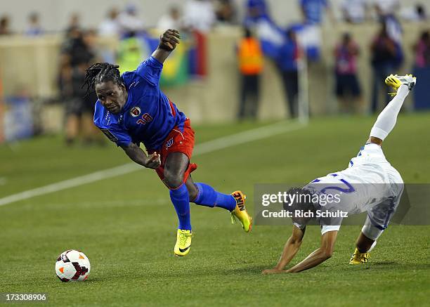Forward Leonel Saint Preux of Haiti moves with the ball past midfielder Edder Delgado defends during the first half in a 2013 CONCACAF Gold Cup...