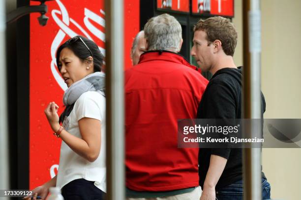 Chairman and CEO of Facebook Mark Zuckerberg follows his wife Priscilla Chan after lunch during the Allen & Co. Annual conference at the Sun Valley...