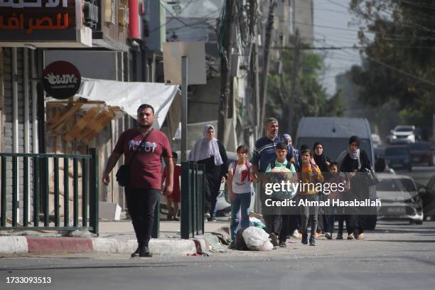 Palestinians displaced from their homes as a result of Israeli air raids on October 13, 2023 in Gaza City, Gaza. Israel has sealed off Gaza and...