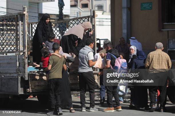 Palestinians displaced from their homes as a result of Israeli air raids on October 13, 2023 in Gaza City, Gaza. Israel has sealed off Gaza and...