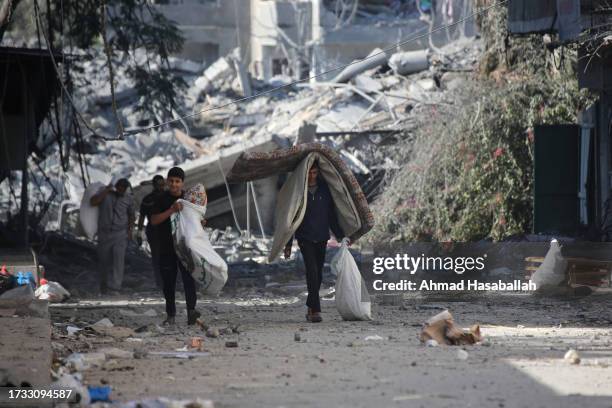 Palestinians displaced from their homes as a result of Israeli air raids on October 13, 2023 in Gaza City, Gaza. Israel has sealed off Gaza and...