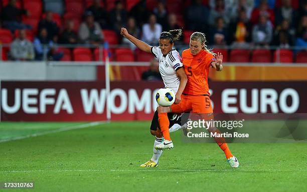 Lena Lotzen of Germany battles for the ball with Claudia van den Heiligenberg of Netherlands during the UEFA Women's Euro 2013 group B match at Vaxjo...