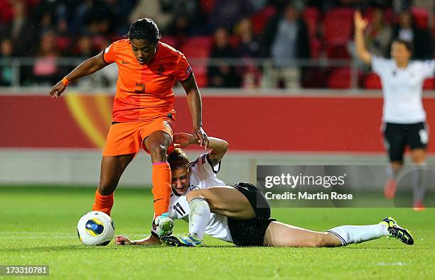 Anja Mittag of Germany battles for the ball with Dyanne Bito of Netherlands during the UEFA Women's Euro 2013 group B match at Vaxjo Arena on July...
