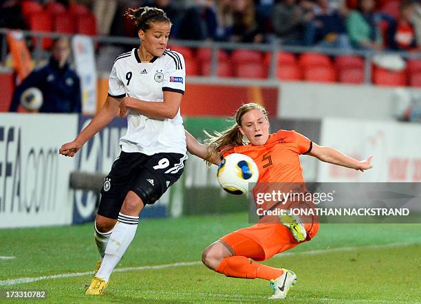 Germany's midfielder Lena Lotzen and Dutch defender Claudia van den Heiligenberg vie for the ball during the UEFA Women's European Championship Euro...