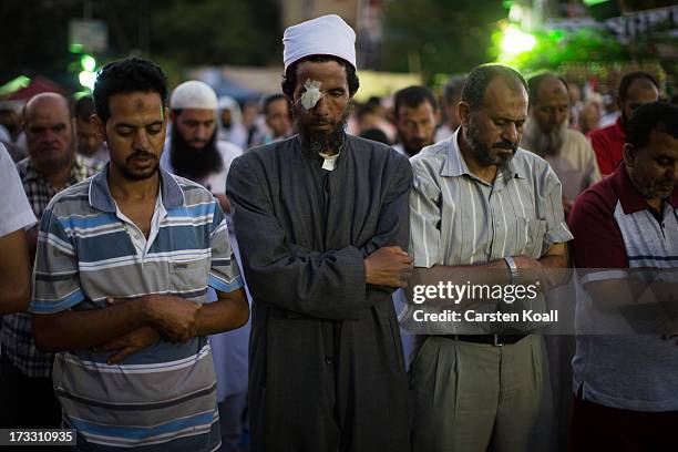 Supporters of ousted president Mohamed Morsi pray before breaking the daily Ramadan fast on the second day of Ramadan, the sacred holy month for...