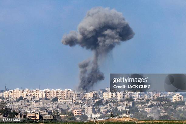 This picture taken from Israel's southern city of Sderot shows a smoke plume erupting during Israeli bombardment in the northern Gaza Strip on...