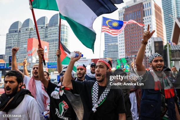 Palestinians living in Malaysia gather to protest in solidarity in the wake of the conflict between Israel and Hamas in the Gaza Strip after Friday...