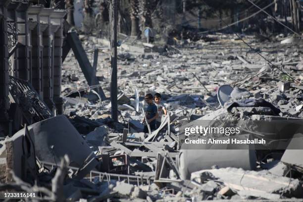 Palestinian citizens inspect damage to their homes caused by Israeli airstrikes on October 13, 2023 in Gaza City, Gaza. Israel has sealed off Gaza...