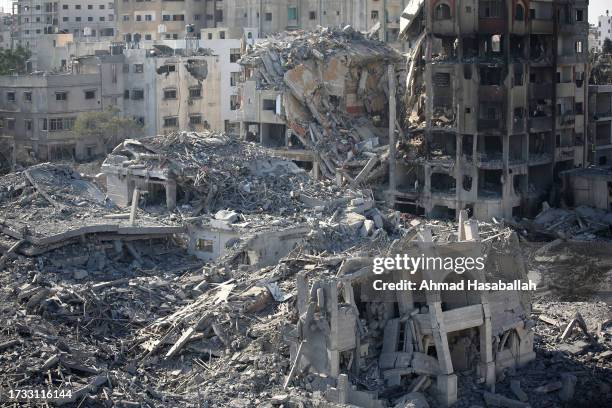 Palestinian citizens inspect damage to their homes caused by Israeli airstrikes on October 13, 2023 in Gaza City, Gaza. Israel has sealed off Gaza...